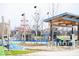This colorful community playground features climbing structures, a modern shelter, and picnic tables at 12484 E 156Th St, Noblesville, IN 46060