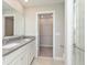 Well-lit bathroom with double sink vanity, modern fixtures, and glass-enclosed shower with a view to the walk-in closet at 1249 Langham St, Avon, IN 46123