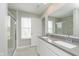 Contemporary bathroom with a double sink vanity, granite countertop, and a glass-enclosed shower at 1249 Langham St, Avon, IN 46123