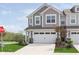 Charming two-story townhome with attached garage, stone accents, and manicured lawn at 1249 Langham St, Avon, IN 46123