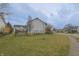 Spacious backyard with lush green lawn, black chain-link fence, and mature trees at 1501 Willshire Dr, Greenwood, IN 46143