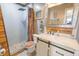 Rustic bathroom featuring a corrugated metal shower, stone floor, and white marble vanity top at 1501 Willshire Dr, Greenwood, IN 46143