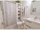Cozy white bathroom featuring a vanity with modern sink, toilet, and shower with decorative curtain at 1501 Willshire Dr, Greenwood, IN 46143