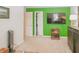 Bright bedroom with green accent wall, closet, and a large flat-screen TV at 1501 Willshire Dr, Greenwood, IN 46143
