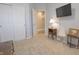 Bedroom showcasing a TV, closet, side table with lamp, and doorway leading to another room at 1501 Willshire Dr, Greenwood, IN 46143