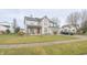 Well-maintained two-story home with a manicured lawn, charming front porch, and convenient two-car attached garage at 1501 Willshire Dr, Greenwood, IN 46143