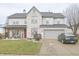 Charming two-story home with a well-manicured lawn, gray siding and brick accents and attached two car garage at 1501 Willshire Dr, Greenwood, IN 46143