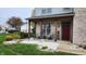 Inviting covered front porch with seating area, a red front door and decorative landscaping at 1501 Willshire Dr, Greenwood, IN 46143