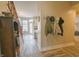 Hallway with coat rack leading to a dining area and kitchen with natural lighting at 1501 Willshire Dr, Greenwood, IN 46143
