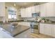 Charming kitchen with white cabinets, stainless steel appliances, and stone countertops at 1501 Willshire Dr, Greenwood, IN 46143