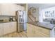 Bright kitchen with stainless refrigerator, stone countertops, and access to the living area at 1501 Willshire Dr, Greenwood, IN 46143
