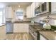 Well-lit kitchen with stainless steel appliances and ample countertop space for meal preparation at 1501 Willshire Dr, Greenwood, IN 46143
