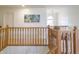 Landing featuring wood railing with view of stairs and a decorative painting hanging on the wall at 1501 Willshire Dr, Greenwood, IN 46143