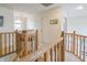 Landing with wood railing featuring a carpeted floor and a view to the lower level at 1501 Willshire Dr, Greenwood, IN 46143