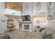 Open-concept living room with vaulted ceiling, fireplace, TV, and modern decor with hardwood floors at 1501 Willshire Dr, Greenwood, IN 46143