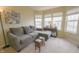 Comfortable living room with large windows, neutral colors, and a cozy sectional sofa at 1501 Willshire Dr, Greenwood, IN 46143