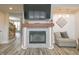 Inviting living room with modern fireplace, TV, and comfortable seating area with hardwood floors at 1501 Willshire Dr, Greenwood, IN 46143