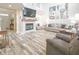 Spacious living room with fireplace, TV, large sofa, and hardwood flooring at 1501 Willshire Dr, Greenwood, IN 46143