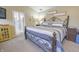 The main bedroom features an ensuite bath, a neutral color palette, and comfortable bedding at 1501 Willshire Dr, Greenwood, IN 46143
