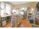 Spacious office with hardwood floors, a large window, rolling storage carts, and built in shelving at 1501 Willshire Dr, Greenwood, IN 46143