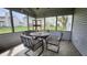 Cozy screened porch with a round table and four chairs, perfect for outdoor dining and relaxation at 1501 Willshire Dr, Greenwood, IN 46143