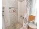 Modern shower with sleek tile, pebble floor, and convenient built-in shelving niche at 1501 Willshire Dr, Greenwood, IN 46143