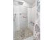 Contemporary shower featuring stylish tile accents, a built-in bench, and modern shower head at 1501 Willshire Dr, Greenwood, IN 46143
