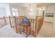 Upstairs hallway with wooden railing, neutral carpet, and accent lighting to the upper level bedrooms at 1501 Willshire Dr, Greenwood, IN 46143