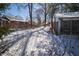 Exterior shot of a red brick house with snow covered yard and trees in the background at 1701 Broad Ripple Ave, Indianapolis, IN 46220