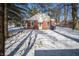 Exterior shot of a red brick house and snowy backyard with trash receptacles at 1701 Broad Ripple Ave, Indianapolis, IN 46220