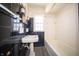Bathroom featuring black tile, a sink, toilet and a tub with shower at 1701 Broad Ripple Ave, Indianapolis, IN 46220