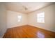 Bedroom with hardwood floors, ceiling fan and natural light from two windows at 1701 Broad Ripple Ave, Indianapolis, IN 46220