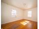 Bright bedroom with hardwood floors and natural light from two windows at 1701 Broad Ripple Ave, Indianapolis, IN 46220