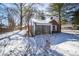 Quaint brick home featuring a screened-in porch and snow covered yard at 1701 Broad Ripple Ave, Indianapolis, IN 46220