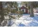 View of a brick home with white trim, surrounded by snow and trees at 1701 Broad Ripple Ave, Indianapolis, IN 46220