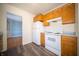 Kitchen featuring wood cabinets, white appliances, and light gray countertops at 1701 Broad Ripple Ave, Indianapolis, IN 46220