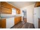 Kitchen featuring wood cabinets, white appliances, and stainless steel sink at 1701 Broad Ripple Ave, Indianapolis, IN 46220