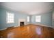 Spacious living room featuring hardwood floors and a decorative fireplace at 1701 Broad Ripple Ave, Indianapolis, IN 46220