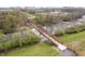 Aerial shot of pedestrian bridge surrounded by nature with city skyline view at 1842 Milburn St, Indianapolis, IN 46202