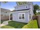 Well-kept backyard with lush green grass, a paved walkway, and a partial view of the house at 1842 Milburn St, Indianapolis, IN 46202