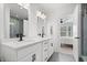 Bright bathroom with double sink vanity, modern lighting, and a glass-enclosed shower at 1842 Milburn St, Indianapolis, IN 46202