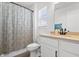 Clean bathroom with a modern vanity, decorative curtain, and a window at 1842 Milburn St, Indianapolis, IN 46202