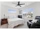 Cozy bedroom features a ceiling fan, large window, and a comfortable armchair at 1842 Milburn St, Indianapolis, IN 46202