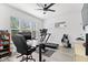 Bright home gym features modern fitness equipment, a ceiling fan, and large windows for natural light at 1842 Milburn St, Indianapolis, IN 46202