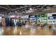 Interior of the Marketplace featuring diverse vendors like Mambo's, Black Orchid Barbers, and dining areas at 1842 Milburn St, Indianapolis, IN 46202