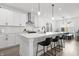Modern kitchen with white countertops, stainless steel appliances, and a breakfast bar with seating at 1842 Milburn St, Indianapolis, IN 46202