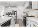 Beautiful modern kitchen featuring white cabinetry, stainless steel appliances, and a large center island at 1842 Milburn St, Indianapolis, IN 46202