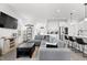 Open-concept living room with a plush sectional sofa, leading into a modern kitchen and dining area at 1842 Milburn St, Indianapolis, IN 46202
