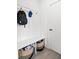 Functional mudroom with a bench, hooks for storage, and baskets for organization at 1842 Milburn St, Indianapolis, IN 46202