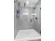 Modern shower with gray tiling, a glass door, and built-in shelving at 1842 Milburn St, Indianapolis, IN 46202